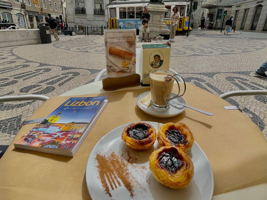 Savoring Pastéis de Nata with coffee in a Lisbon café, with iconic tram in the backdrop.