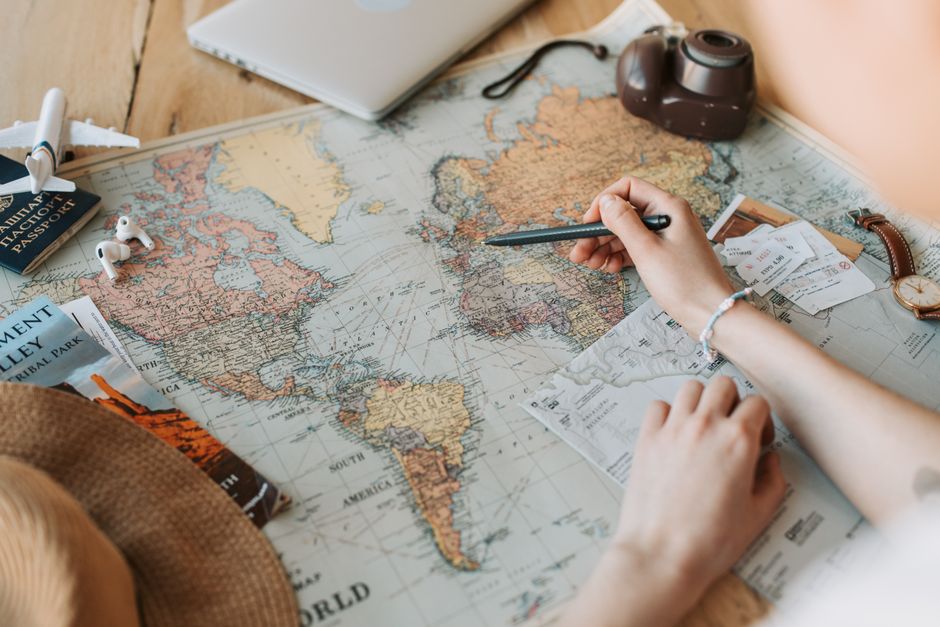 A brown envelope placed on a vintage world map, offering an adventurous theme.